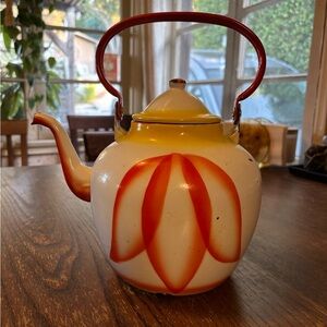 Vintage Enamelware teakettle with orange and yellow petal design.
